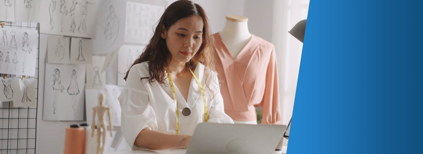 Woman on her laptop in her clothing store